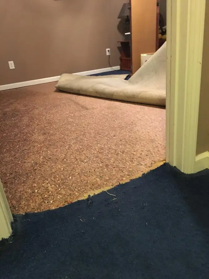 Carpet pad removal revealing water damage during Drying & Dehumidification in Merced